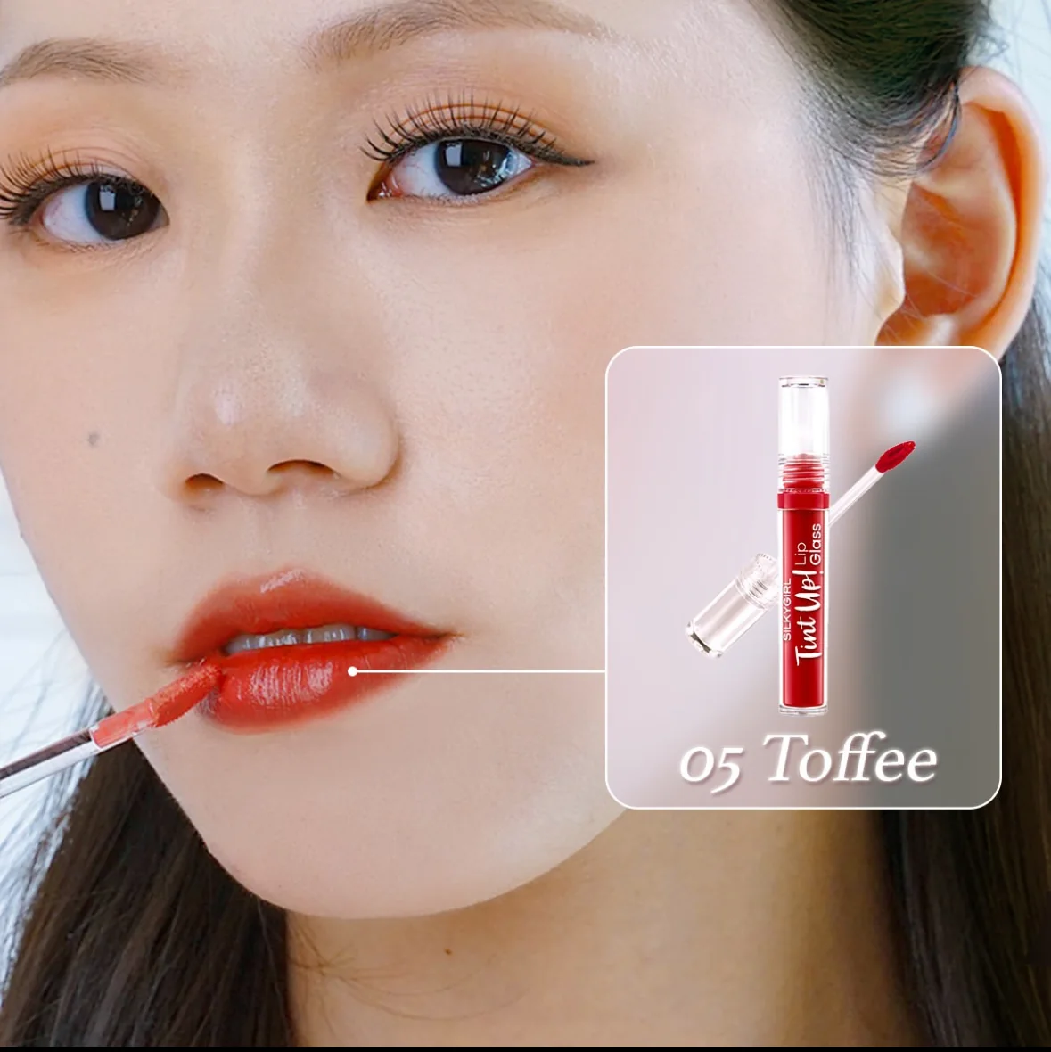Beauty campaign: a close-up of a model applying lip tint, the product shown beside her face